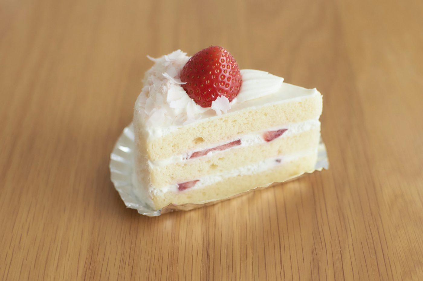 A slice of strawberry sponge on a plate