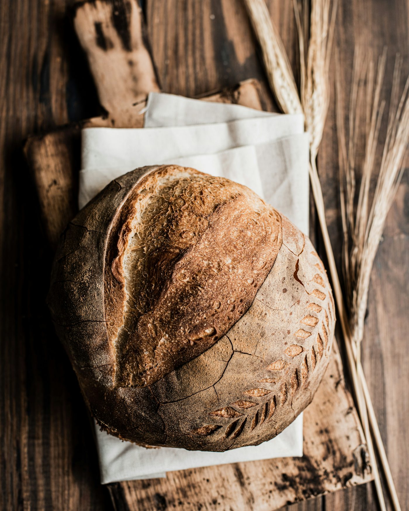 A sourdough loaf cooling on a board